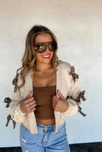 Load image into Gallery viewer, The trendiest cardigan of the season and sure to be a HIT! These crop knit, open front cardigans featuring knit camo and cheetah bows with a slight bubble sleeve arm.