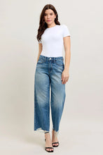 Load image into Gallery viewer, Unleash your inner fashionista with our HW Destroy Hem Crop Wide Leg Jeans by Judy Blue. Made with a high waist and rigid magic construction, these jeans are designed to flatter your figure while providing all-day comfort. The destroyed hem and wide leg a