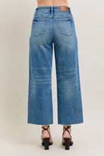 Load image into Gallery viewer, Unleash your inner fashionista with our HW Destroy Hem Crop Wide Leg Jeans by Judy Blue. Made with a high waist and rigid magic construction, these jeans are designed to flatter your figure while providing all-day comfort. The destroyed hem and wide leg a