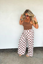 Load image into Gallery viewer, These washed printed pants scream ultimate comfort and style. These trendy pants feature side sesam piping details, side pockets and elastic waist with tie string. Waist is designed to be "rolled" but can absolutely be unrolled as well. The BEST parte is