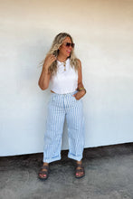 Load image into Gallery viewer, These trendy stripe barrels have more of a mid-rise fit, semi stretchy denim, and wide-legs that taper at the ankle. Darted at the knees to keep the "flare out" form. Features beltloops and detailed seams on sides. High quality look! Medium wash with a d