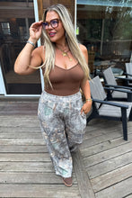 Load image into Gallery viewer, These washed printed pants scream ultimate comfort and style. These trendy pants feature side sesam piping details, side pockets and elastic waist with tie string. Waist is designed to be "rolled" but can absolutely be unrolled as well. The BEST parte is