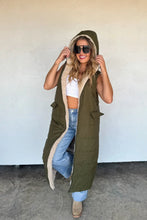 Load image into Gallery viewer, Stay warm in bold style with the ultra-cozy long sherpa puffer vest. Quilted puffer on one side, or wear it reversed with the sherpa side facing out! Features side pockets on the puffer side with a full zipper. Reverse the vest to wear the sherpa on the