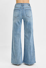 Load image into Gallery viewer, These Risen high-rise wide-leg jeans feature a flattering front yoke detail that adds structure and style. The relaxed fit flows effortlessly from hip to hem, creating a modern, on-trend silhouette. Designed for comfort without sacrificing chic, they’re perfect