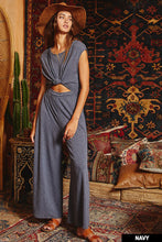 Load image into Gallery viewer, Effortlessly chic and endlessly comfortable, this open front jumpsuit is your go-to for laid-back elegance. Featuring a flattering elastic waistband and breezy wide legs, it drapes beautifully for a relaxed silhouette. The deep open front adds a touch of allure, while the v-neckline at the back with an adjustable drawstring tie brings an unexpected twist. Finished with side pockets for everyday ease, this jumpsuit is perfect for everything from beach days to brunch dates.