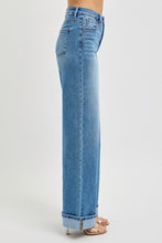 Load image into Gallery viewer, These Michelle - Risen High rise jeans feature a high rise design with tummy control for a flattering fit. The wide cuff detail adds style and versatility, with an 11" rise for comfortable coverage. The inseam measures 32.5" before cuffing and extends to 35" when the cuff is released, allowing for customizable length. Perfect for those seeking both function and fashion in their denim.