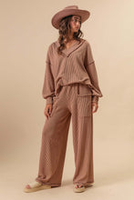 Load image into Gallery viewer, This two-tone Cozy cord rib set blends elevated comfort with effortless style. Designed with a flattering V-neck top and eye-catching contrast stitching, it adds just the right amount of detail to a laid-back look. The soft, ribbed fabric offers stretch and te