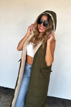 Load image into Gallery viewer, Stay warm in bold style with the ultra-cozy long sherpa puffer vest. Quilted puffer on one side, or wear it reversed with the sherpa side facing out!  Features side pockets on the puffer side with a full zipper.  Reverse the vest to wear the sherpa on the
