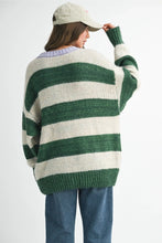 Load image into Gallery viewer, The sweater you’ll live in all season long. This oversized knit features bold forest green stripes and a contrasting lavender neckline for a playful twist. Easy to throw on with jeans or a maxi skirt- cozy, carefree, and totally essential.
