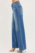 Load image into Gallery viewer, Side view of Baggy - The Emery - Risen Jeans in light blue, featuring a wide-leg design for a trendy look.
