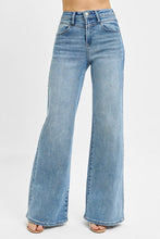 Load image into Gallery viewer, These Risen high-rise wide-leg jeans feature a flattering front yoke detail that adds structure and style. The relaxed fit flows effortlessly from hip to hem, creating a modern, on-trend silhouette. Designed for comfort without sacrificing chic, they’re perfect
